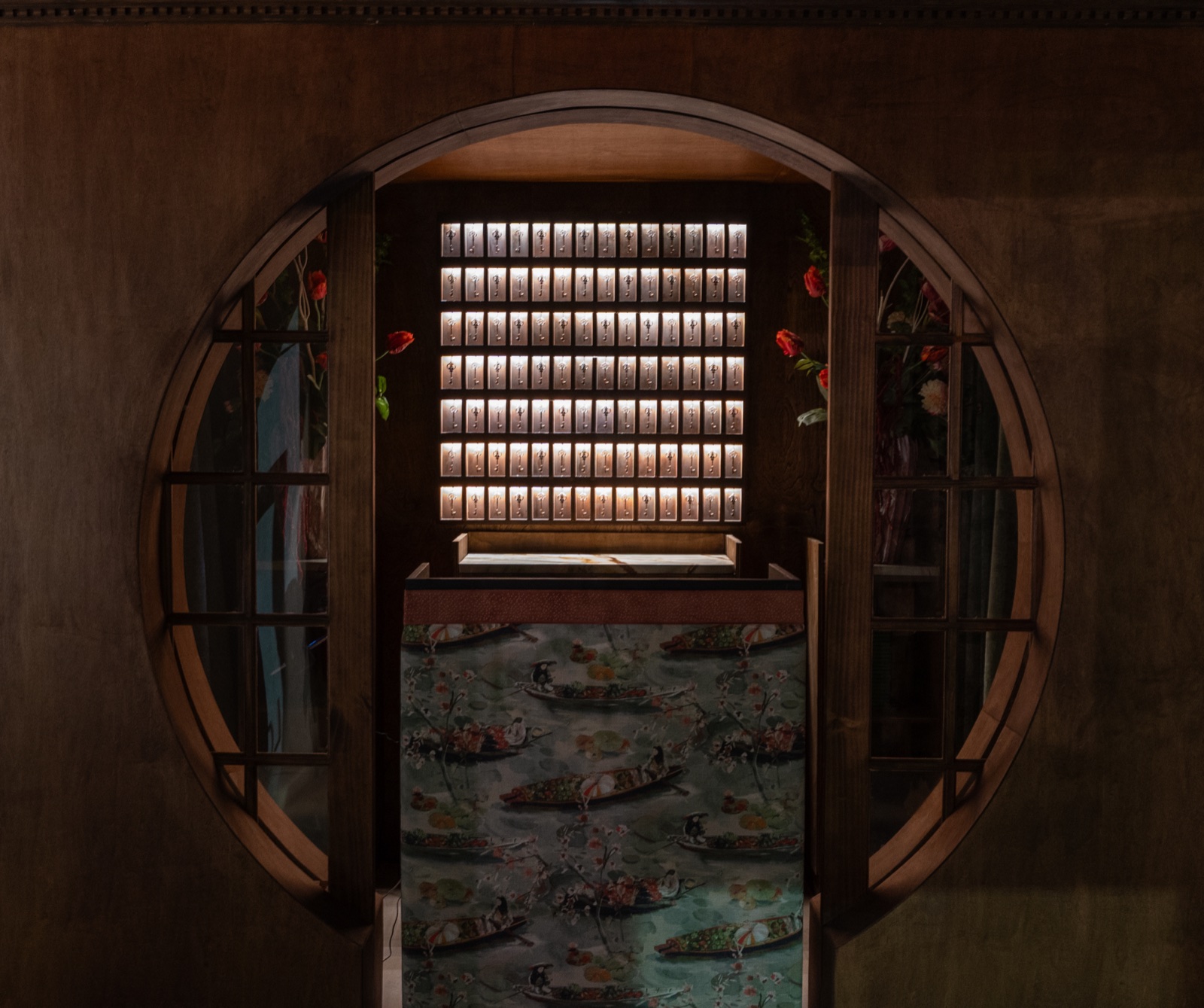 Lo Kee moon gate entrance with illuminated antique key wall
