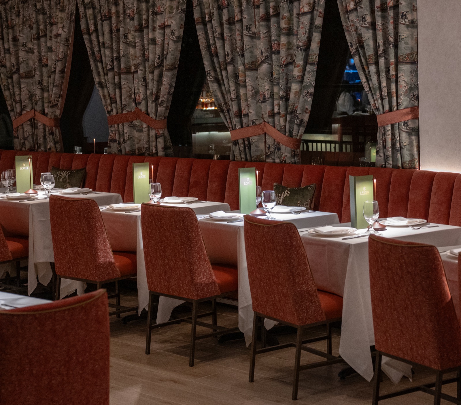 Lo Kee dining room with red banquettes and floral drapery